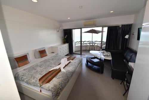 a bedroom with a bed and a living room at VIP CONDO RAYONG 343 in Rayong