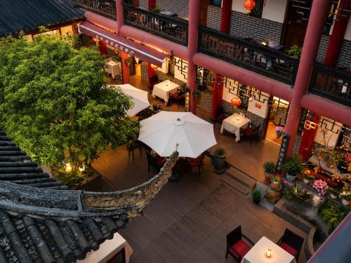 an overhead view of a restaurant with an umbrella at Wenjun Courtyard Hotel Chengdu ,English-Speaking , Pick-up Service ,Laundry Service , Local Tours in Chengdu