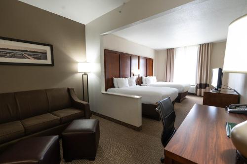 a hotel room with two beds and a couch at Rapid River Lodge in Baxter