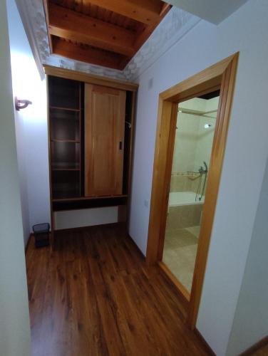 an empty room with a bathroom with a glass door at Golden Minaret with Terrace in Bukhara