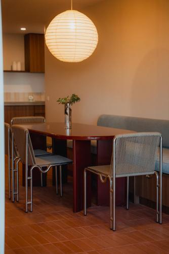 a dining room with a table and chairs at Hillcrest Merimbula in Merimbula