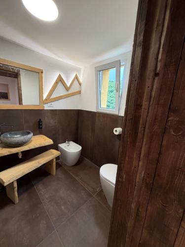 a bathroom with a white toilet and a sink at Chalet Al bosco incantato in Trieste