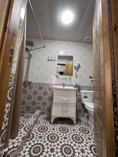 a bathroom with a sink and a toilet at Zarhal boutique Premium in Bukhara