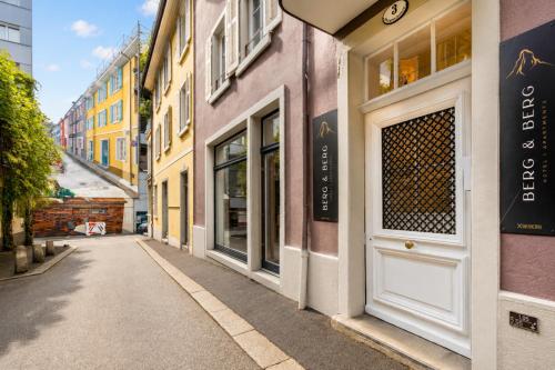 an empty street in a city with colorful buildings at BERG & BERG Apartments - Luzern Self-Check-in in Lucerne