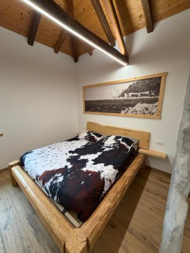 a bedroom with a wooden bed in a room at Chalet Al bosco incantato in Trieste