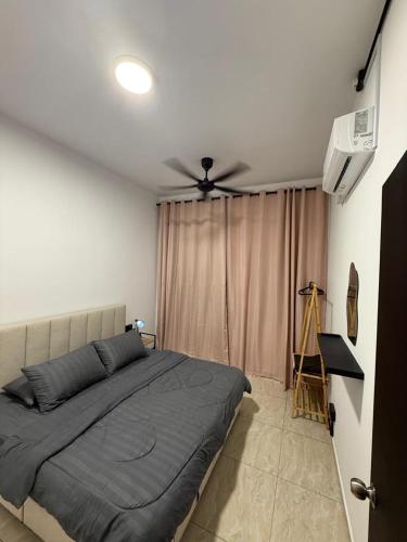 a bedroom with a bed and a ceiling fan at Pool View - H&A Signature Klebang in Malacca