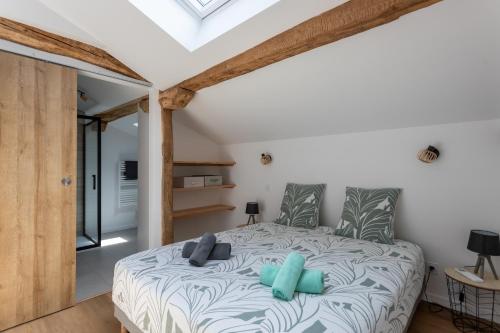 a bedroom with a bed with blue pillows on it at Gite Goxa Leku in Ossès