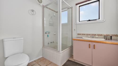 a bathroom with a shower and a toilet and a sink at Feathertop in Dinner Plain