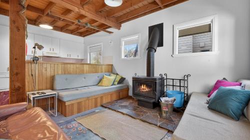 a living room with a couch and a fireplace at Feathertop in Dinner Plain