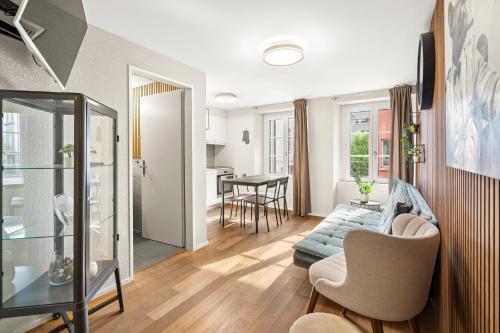 a living room with a couch and a table at BERG & BERG Apartments - Luzern Self-Check-in in Lucerne