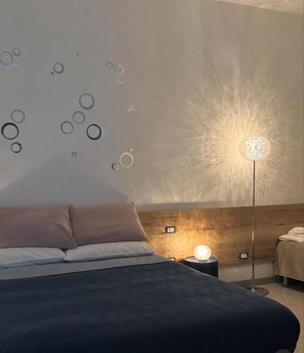 a bedroom with a bed with a blue comforter at Affittacamere Nonna Ia in Lustra