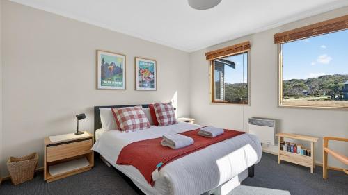 a bedroom with a large bed and a window at Freedom in Dinner Plain
