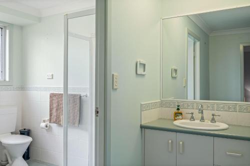 a bathroom with a sink and a mirror at Tranquility Place in Evans Head