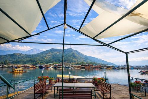 a view of the water from a pier with a table at Heritage Amina Group Of Houseboats in Srinagar