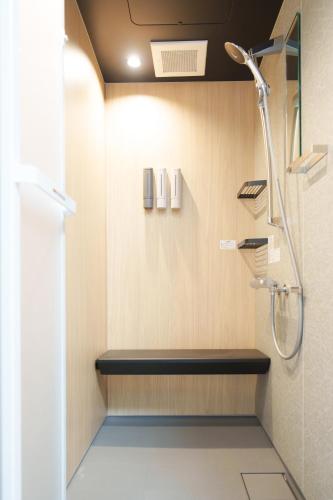 a bathroom with a shower and a bench at Bears Building in Kumamoto