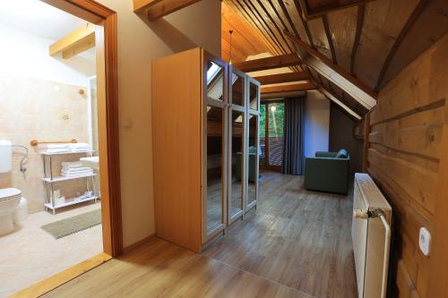 a bathroom with a toilet and a glass cabinet at Vila Edelweiss Rooms&App Kranjska Gora in Kranjska Gora