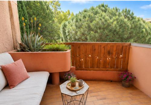 a patio with a couch and a table at Studio Bord de Mer Résidence - Les Sablettes in La Seyne-sur-Mer