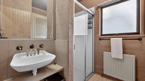 a bathroom with a sink and a shower at Snowgums 10 in Dinner Plain
