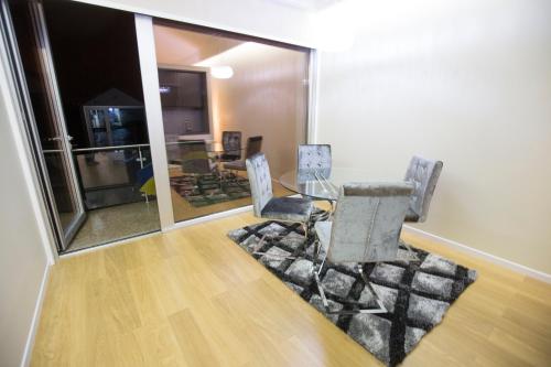 a dining room with a glass table and chairs at Hotel Estalagem Turismo in Bragança