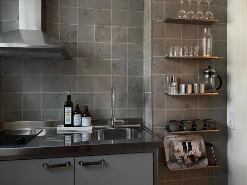a kitchen with a sink and a counter at Badklippan in Stockholm