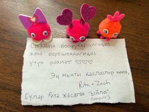 two felt bunnies and a piece of paper at 51 guest house in Bishkek