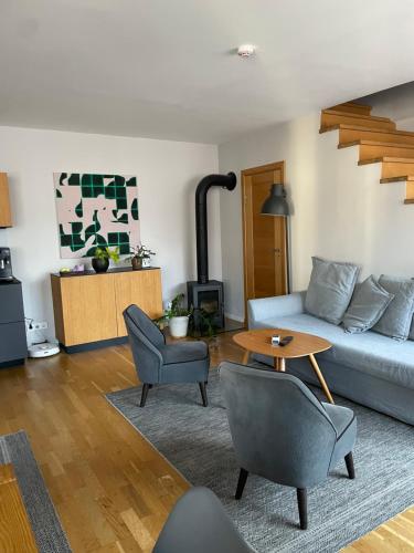 a living room with a couch and a table at Maironis 2 - Grand Apartment in the Heart of Kaunas in Kaunas