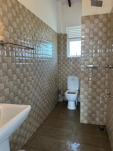 a bathroom with a toilet and a sink at Kandana bliss villa in Kandana