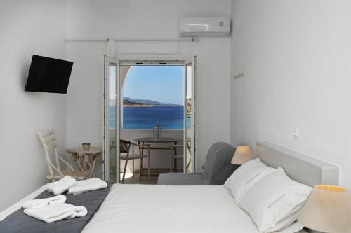 a bedroom with a bed and a view of the ocean at Christina's House in Koufonisia