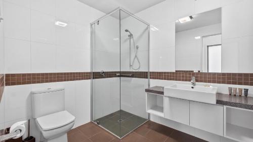 a bathroom with a shower and a toilet and a sink at Triggerplant 2 in Dinner Plain