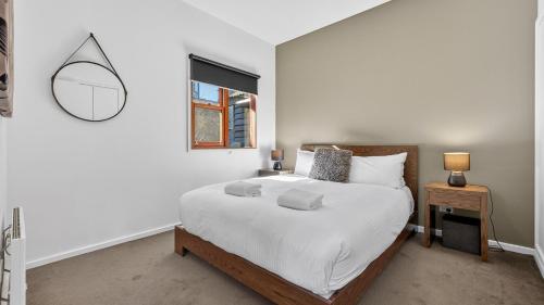 a bedroom with a large bed and a mirror at Triggerplant 2 in Dinner Plain
