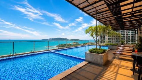 a swimming pool with a view of the ocean at Hon Chong Retreat Hotel Nha Trang in Nha Trang