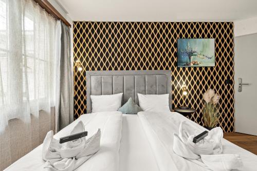 a bedroom with a large bed with white sheets at BERG & BERG Hotel - Hellbühl Self-Check-in in Hellbühl