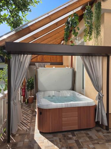 a hot tub on the patio of a house at Apartment Jurček with jacuzzi & sauna in Luče