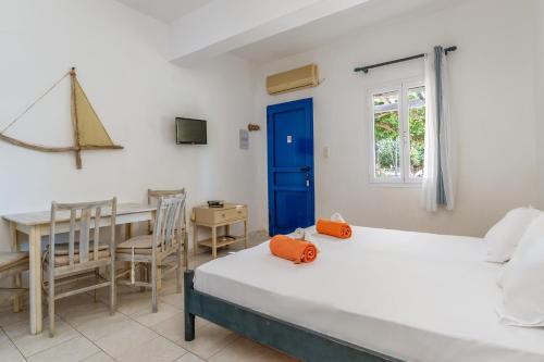 a room with two beds and a table and a desk at Perasma Studios 12 in Kipri