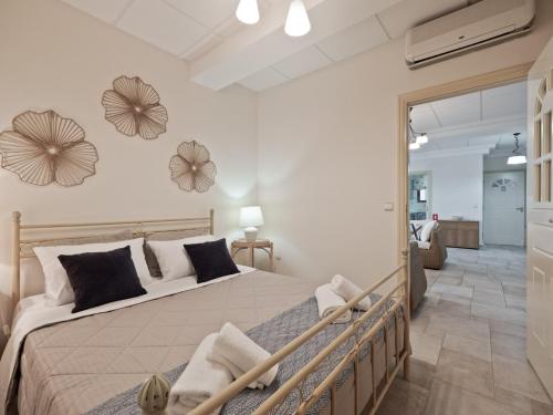 a bedroom with a large bed in a room at Neptune Suite Sounio in Sounio