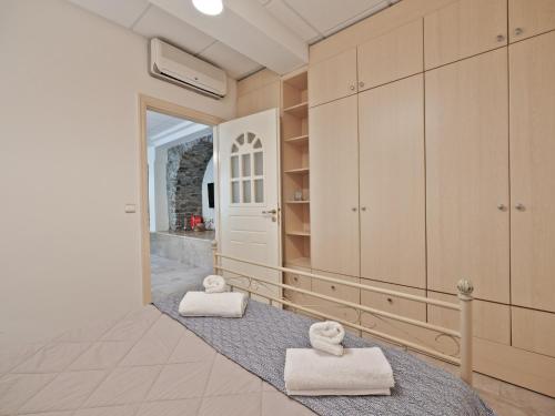 a bathroom with two towels on the floor at Neptune Suite Sounio in Sounio