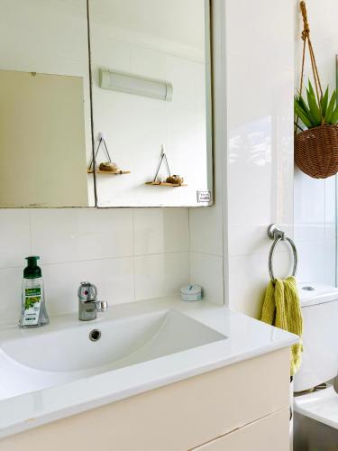 a white bathroom with a sink and a mirror at Cozy Bondi ROOM - Beach life and Local Host! Free Parking in Sydney