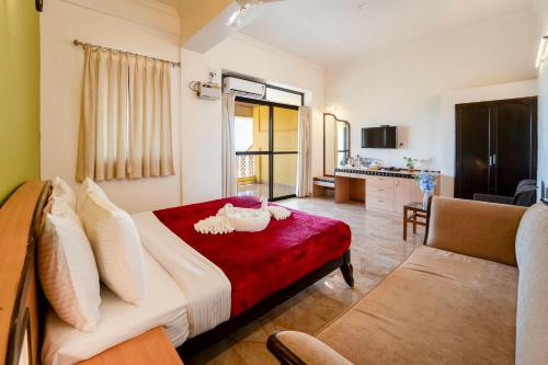 a living room with a bed and a couch at Calangute Residency in Calangute