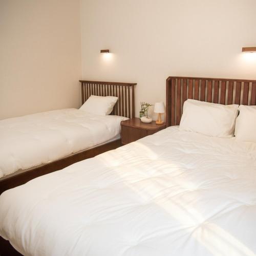 two beds sitting next to each other in a bedroom at sinae stayG in Seoul