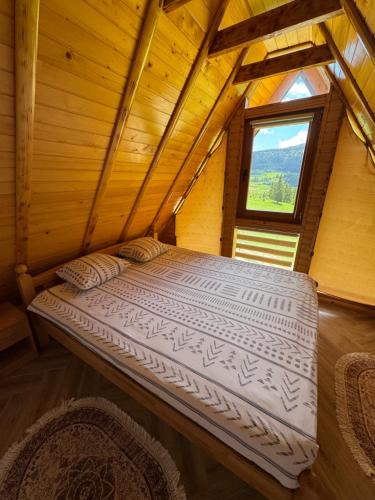 a large bed in a room with a window at Vlasic Odmor - Villa Krajina V in Vlasic