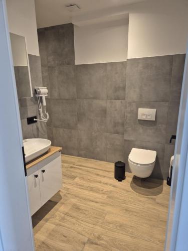 a bathroom with a toilet and a sink at Hotel Elb Blick in Jork