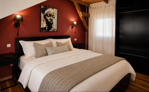 a bedroom with a large bed with red walls at Amber Private Rooms in Riga