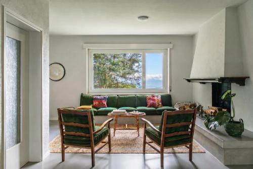 a living room with a green couch and chairs at Luxury Nature Retreat Villa Planchette in Lugano