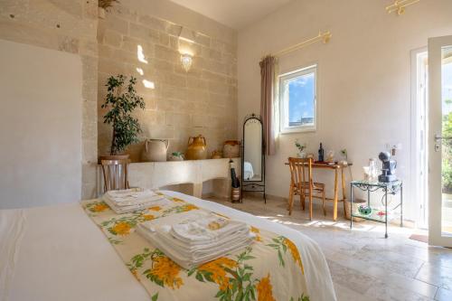 a bedroom with a bed and a table at Giardino Frannicola in Maglie