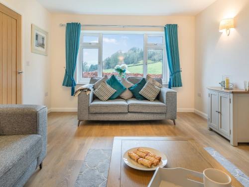 a living room with a couch and a window at Carr View Farm in Bamford