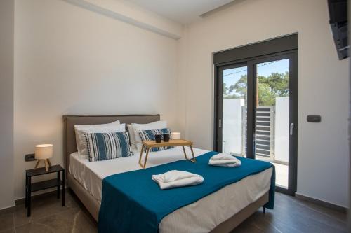 a bedroom with a bed with a blue blanket at Casadi Fileri Villa in Ialysos