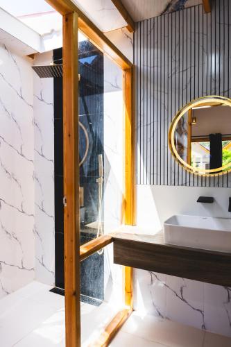 a bathroom with a sink and a mirror at Black Pearl View in Himandhoo 