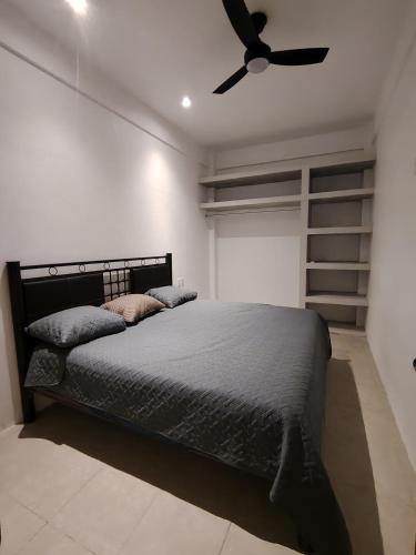 a bedroom with a bed and a ceiling fan at Depas las Palmas in Zihuatanejo