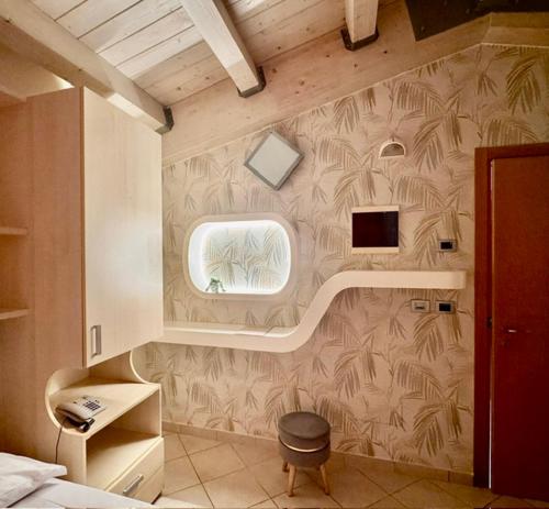 a bedroom with a wall with a mural of palm trees at Melody Hotel in Cervia