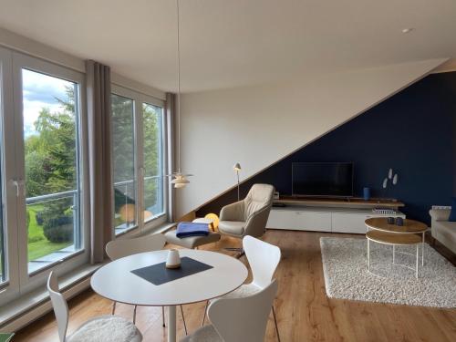 a living room with a couch and a table at Ferienwohnung Seepanorama in Groß Wittensee